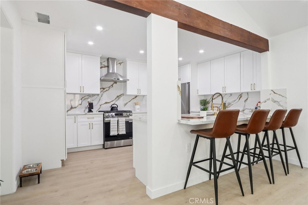 11060 Vanda Way Sun Valley, CA 91352 - Photo 9 of 43 a kitchen with stainless steel appliances kitchen island granite countertop a stove a sink and a refrigerator