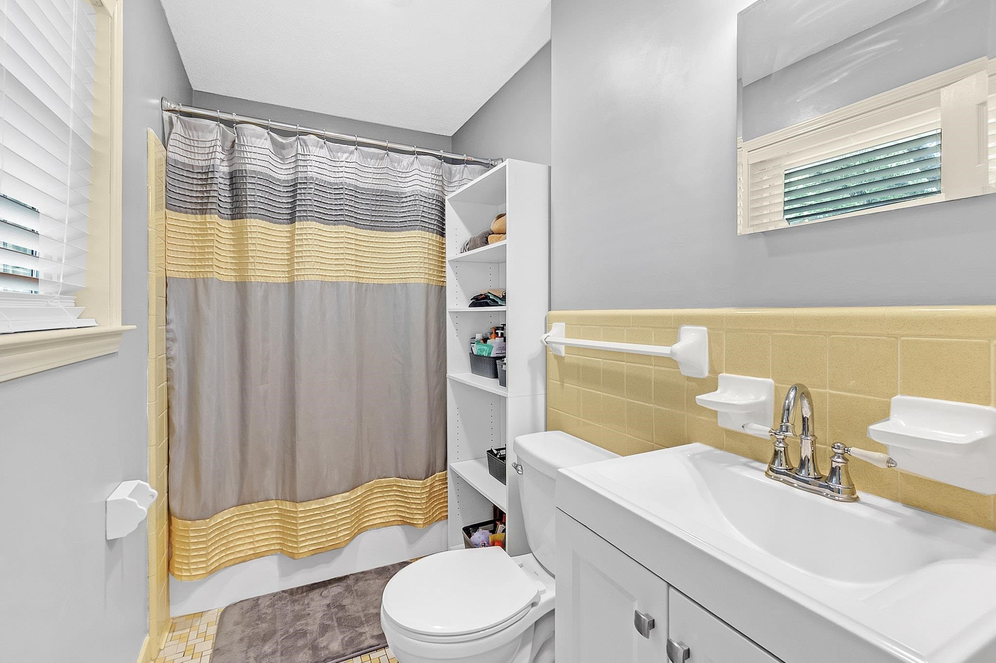 2234 Highway 301 Hernando, MS 38632 - Photo 19 of 27 a bathroom with a sink a toilet and shower curtain