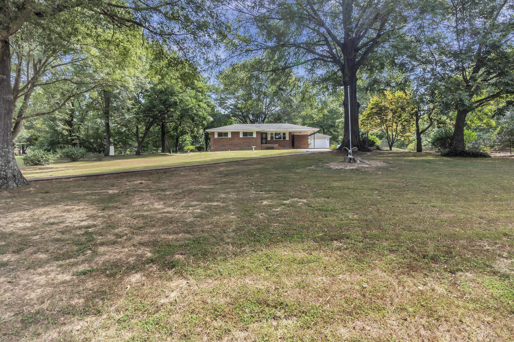 2234 Highway 301 Hernando, MS 38632 - Photo 5 of 27 a house with trees in front of it
