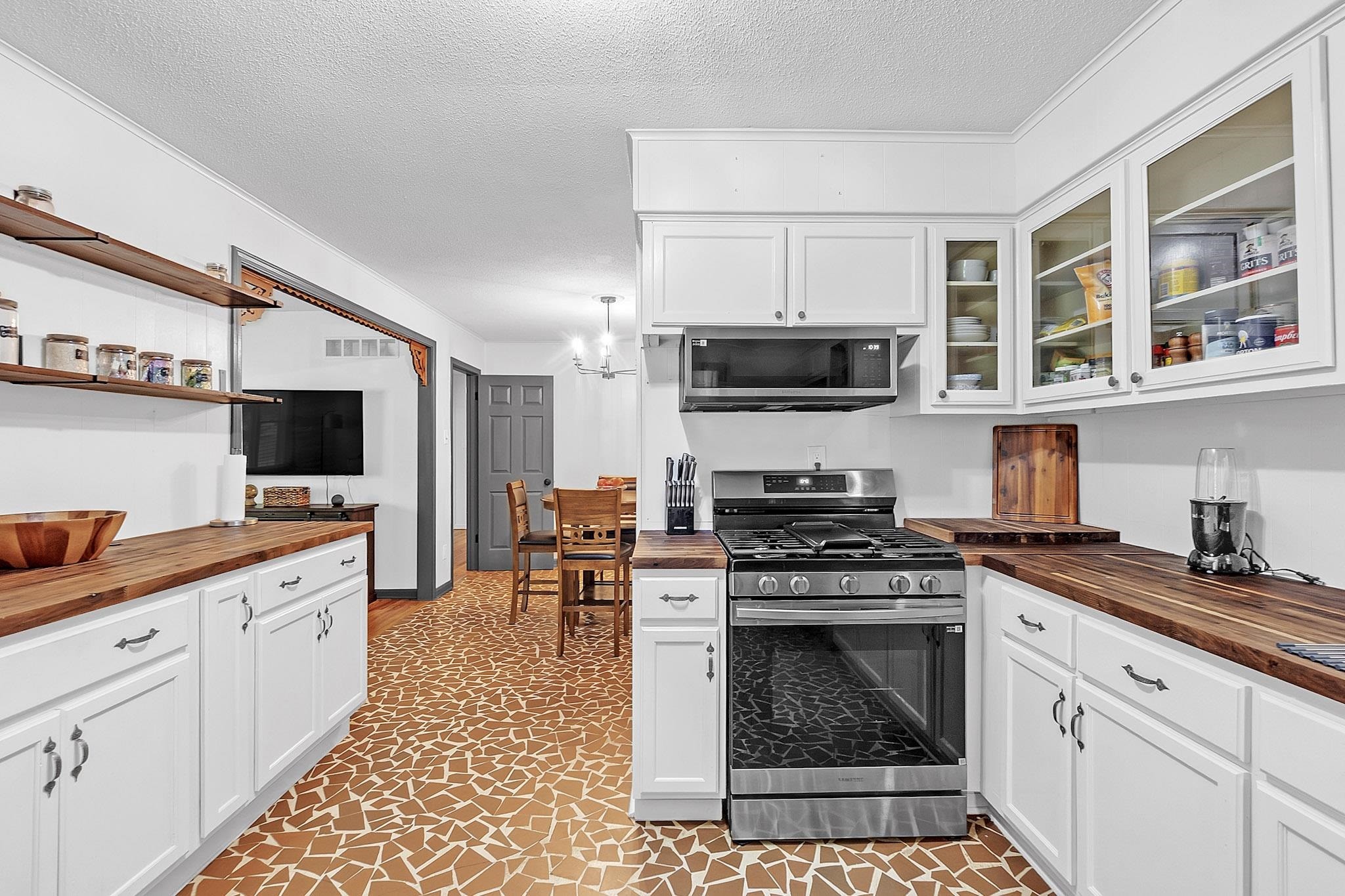 2234 Highway 301 Hernando, MS 38632 - Photo 8 of 27 a kitchen with stainless steel appliances a stove sink microwave and cabinets