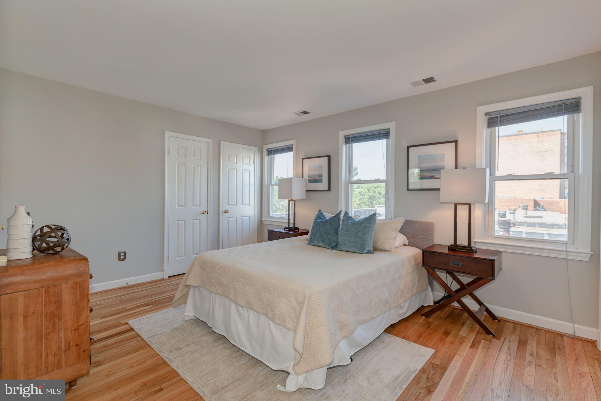 1801 T Street Northwest, Unit C Washington, DC 20009 - Photo 12 of 16 a bedroom with a bed and wooden floor