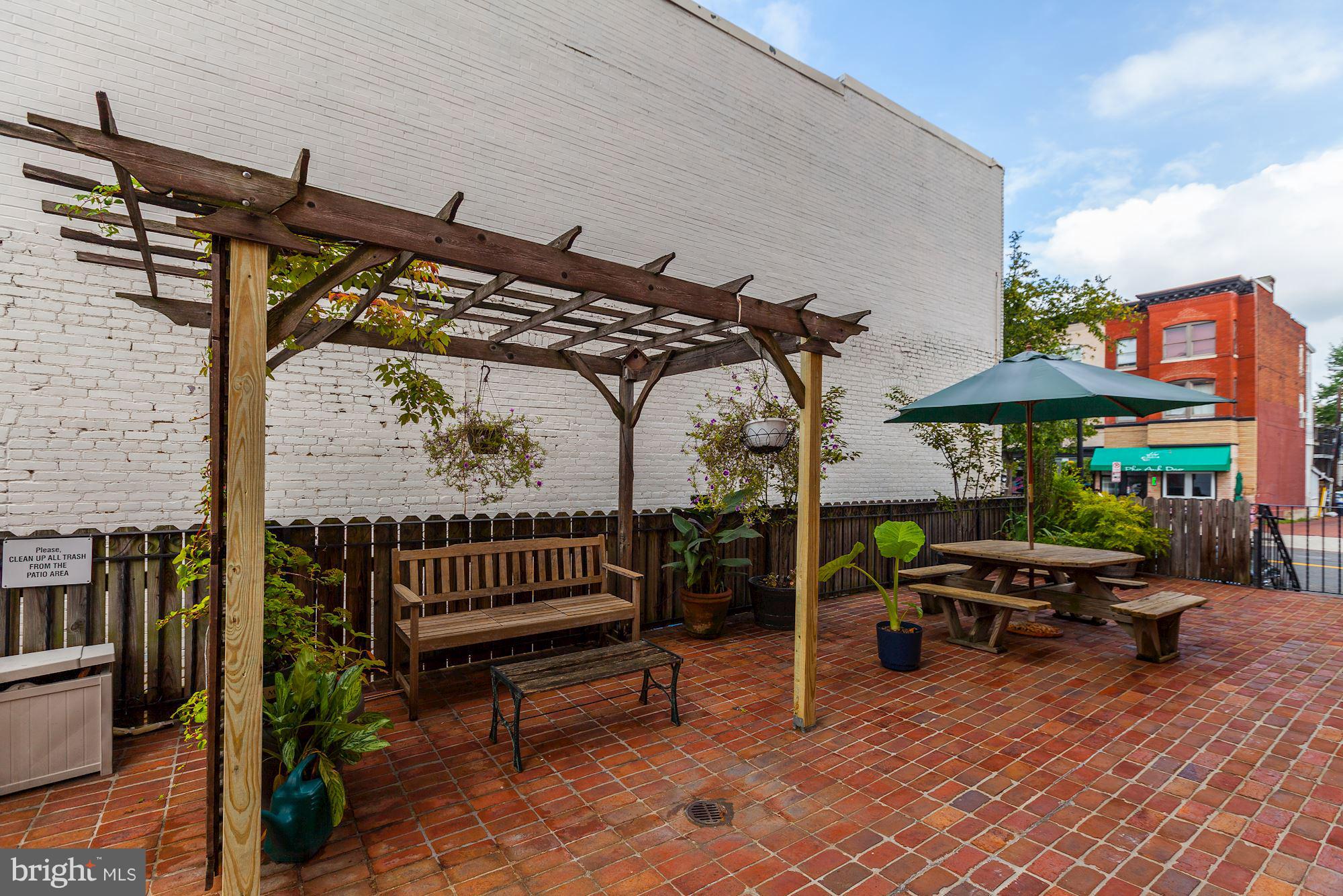1801 T Street Northwest, Unit C Washington, DC 20009 - Photo 14 of 16 a patio with a table and chairs