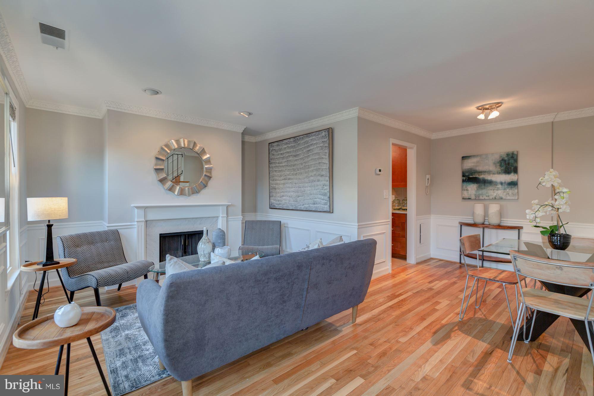 1801 T Street Northwest, Unit C Washington, DC 20009 - Photo 3 of 16 a living room with furniture and a fireplace