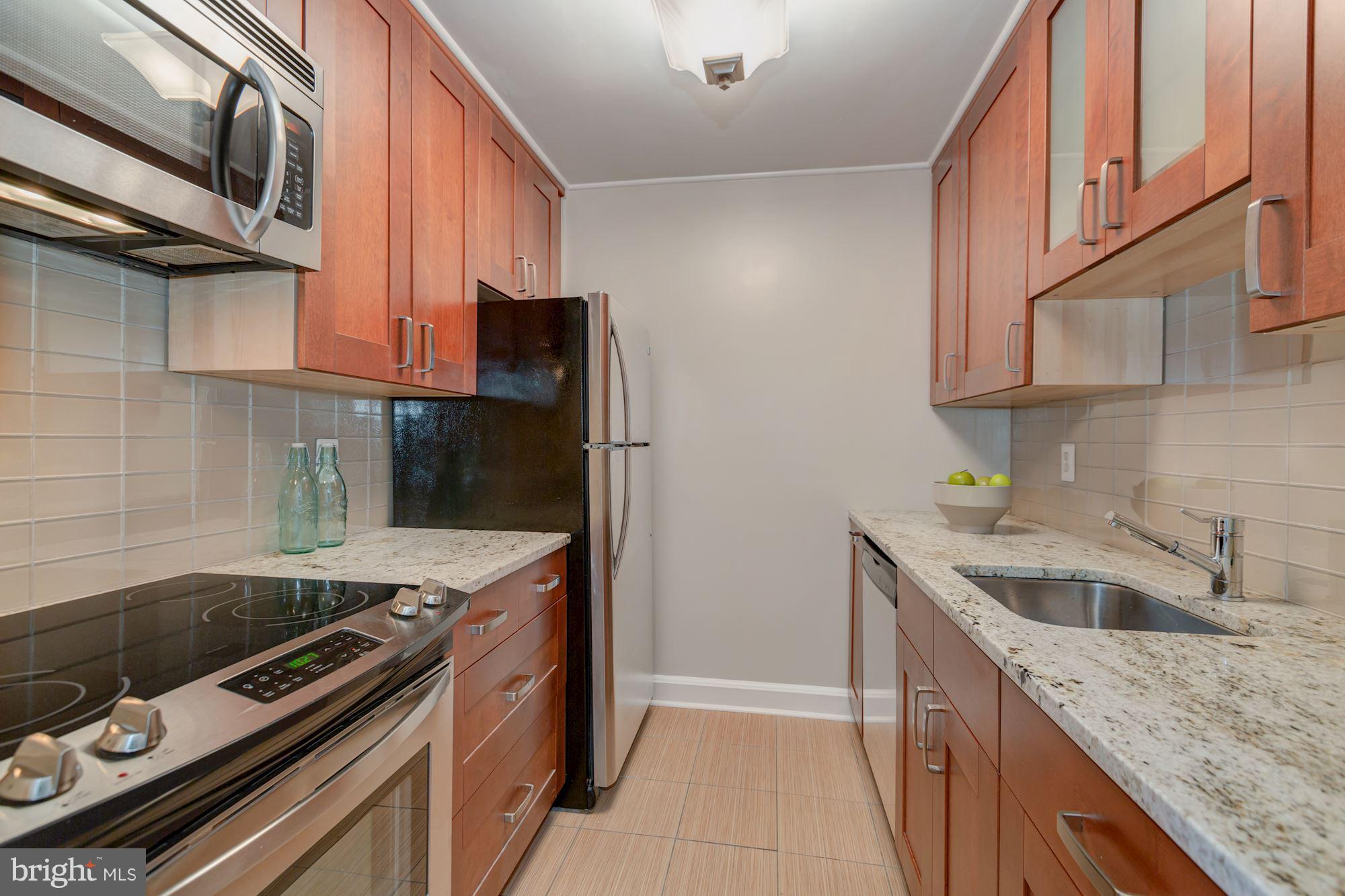1801 T Street Northwest, Unit C Washington, DC 20009 - Photo 8 of 16 a kitchen with a stove and a sink
