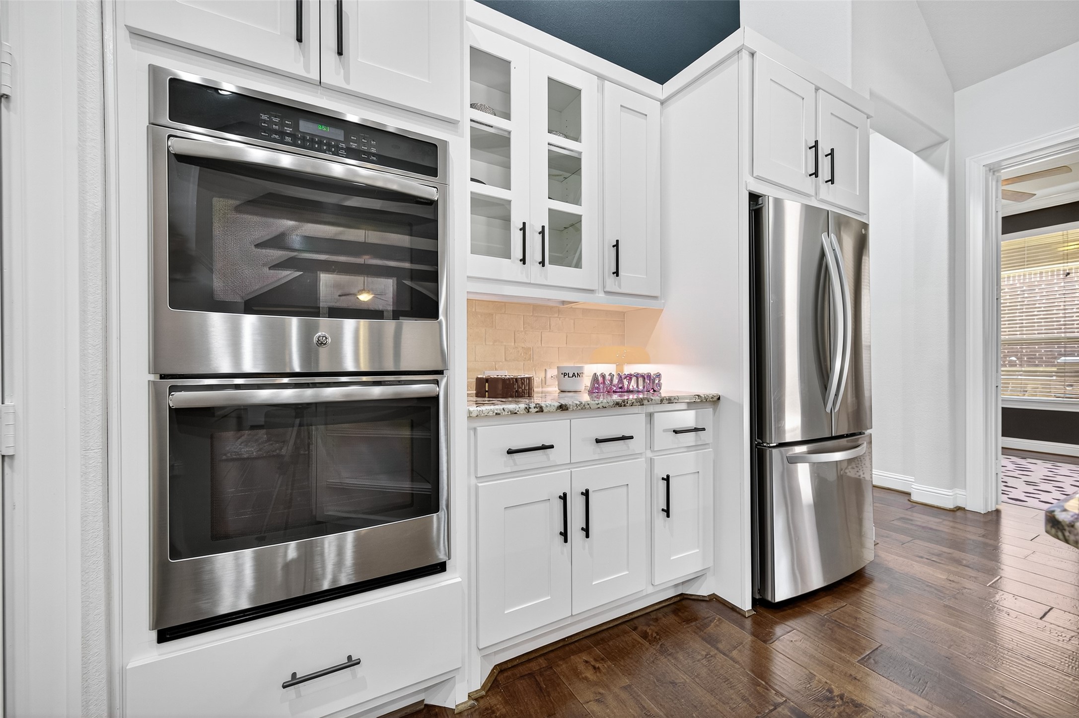 46 Sundown Ridge Place Tomball, TX 77375 - Photo 13 of 46 a kitchen with stainless steel appliances and wooden floor