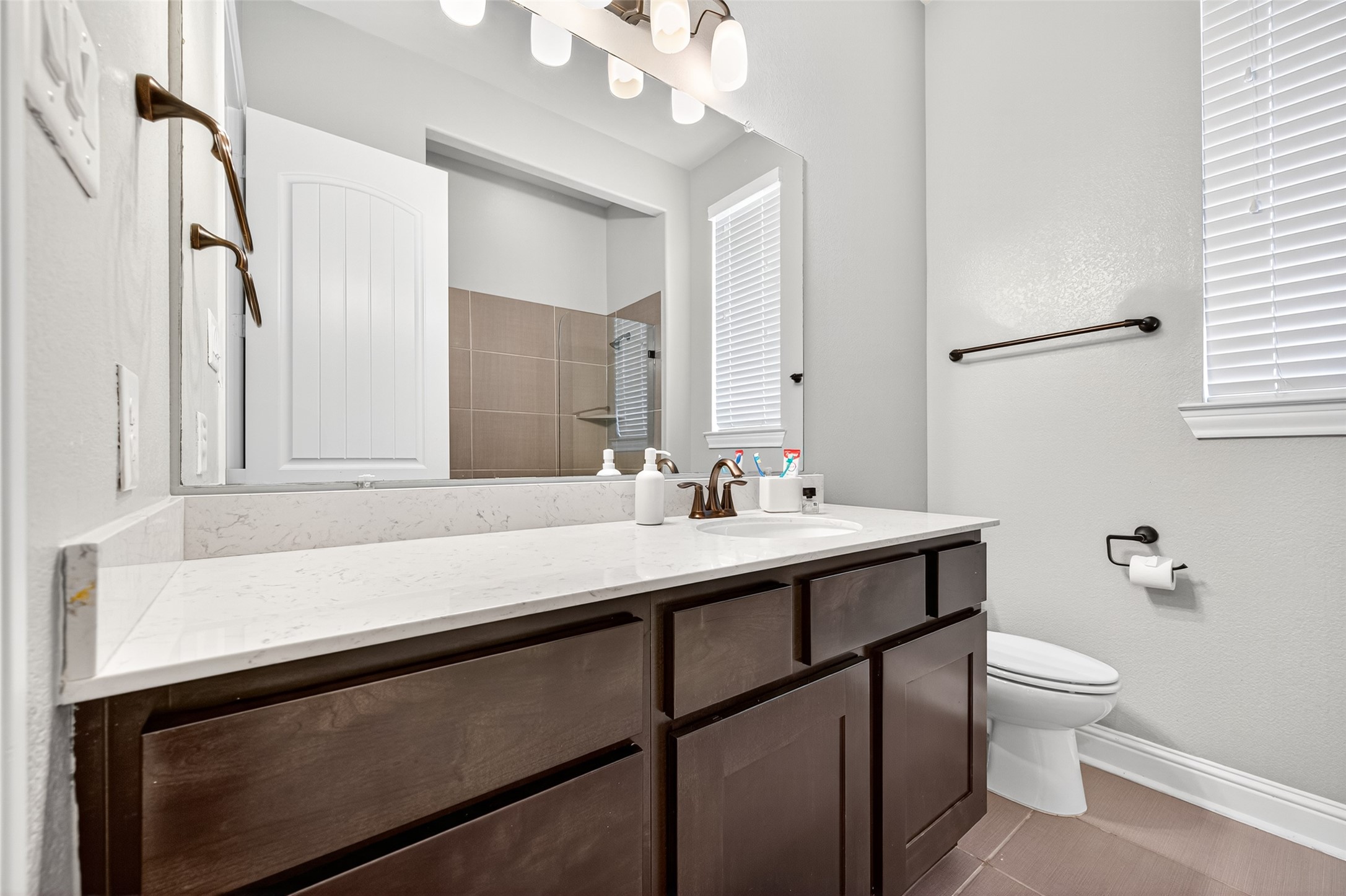 46 Sundown Ridge Place Tomball, TX 77375 - Photo 36 of 46 a bathroom with a sink a toilet a mirror and vanity