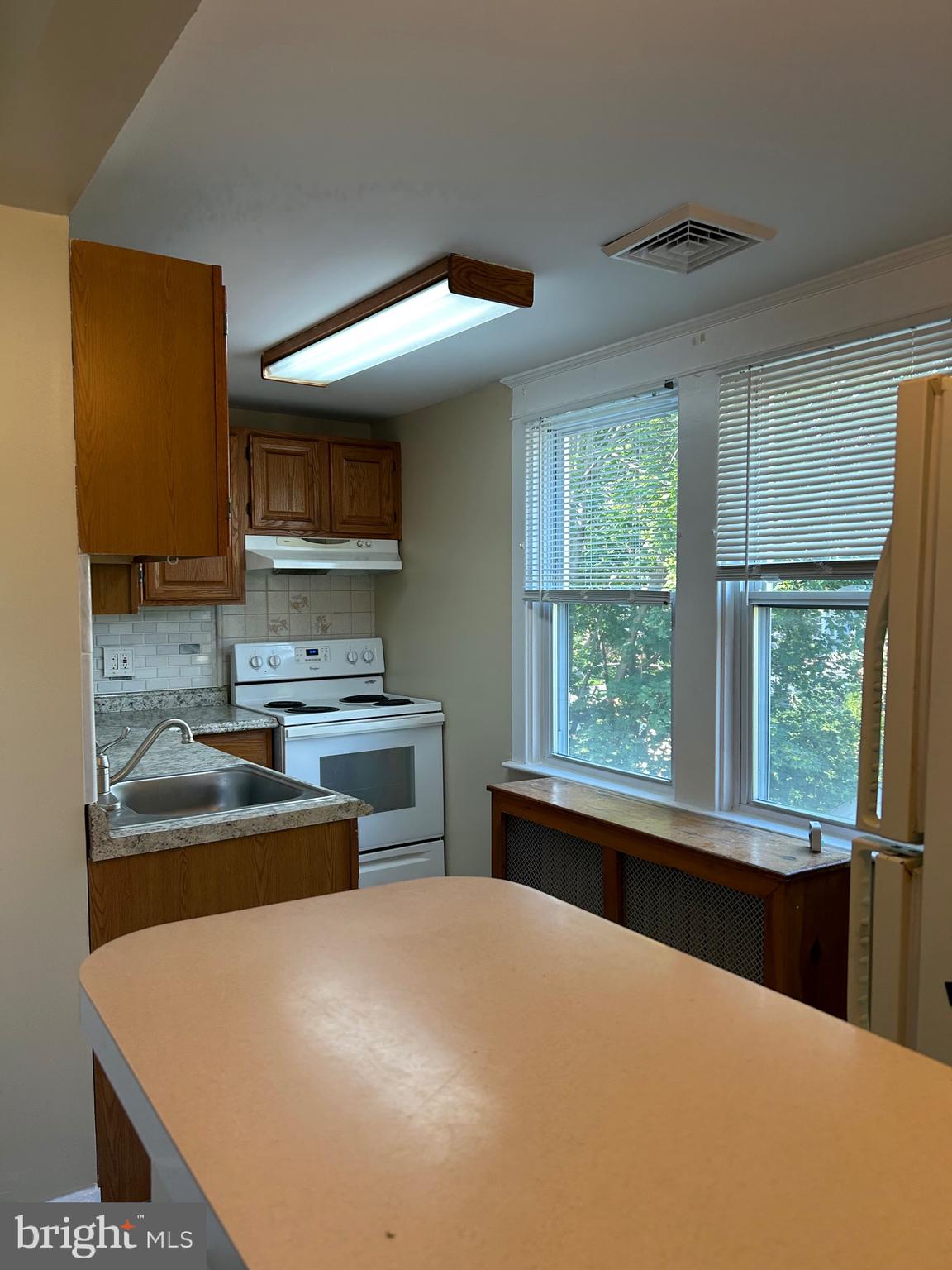 1005 Weller Avenue Havertown, PA 19083 - Photo 2 of 11 a kitchen with a stove a sink and a microwave