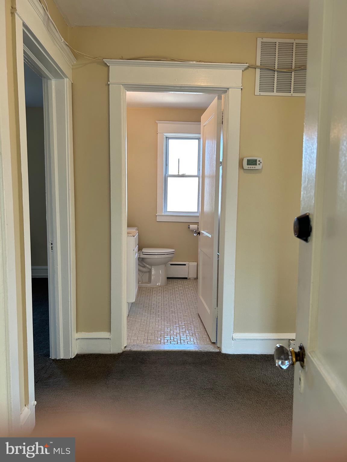 1005 Weller Avenue Havertown, PA 19083 - Photo 7 of 11 a view of a hallway with wooden floor and a bathroom