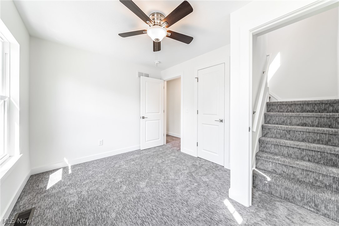 3959 Ardmore Road Cleveland Heights, OH 44121 - Photo 25 of 38 Stairway with ceiling fan and carpet