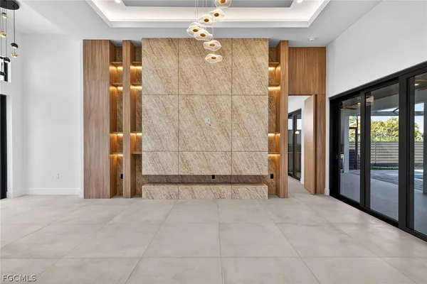 a view of an empty room with closet and a window