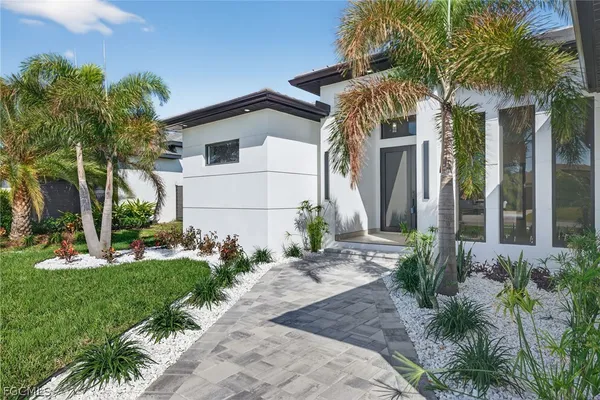 a large white kitchen with a large window