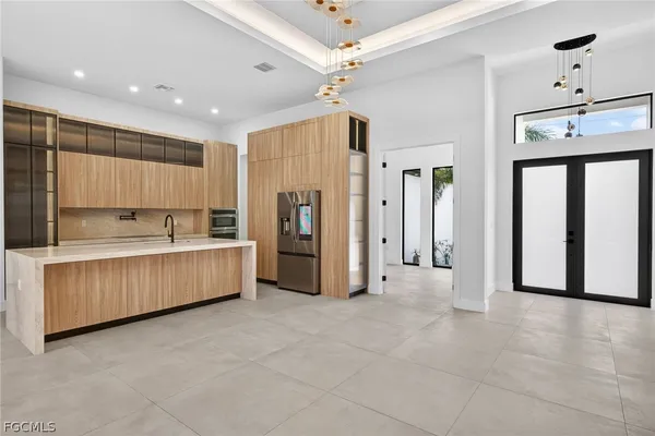 a kitchen with a refrigerator and a sink