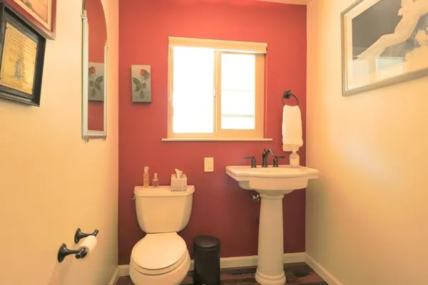 a bathroom with a toilet a sink and a mirror