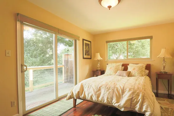 a bedroom with a bed and wooden floor