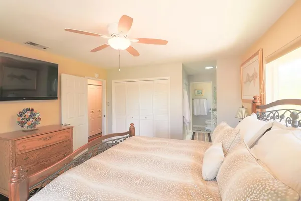 a bedroom with a bed and a flat screen tv