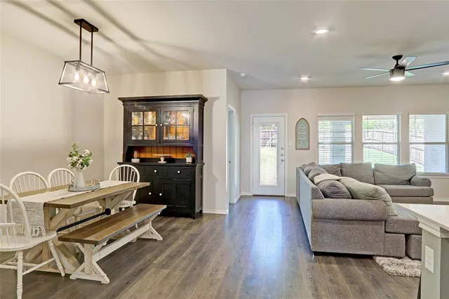 a view of a room with furniture wooden floor and fan