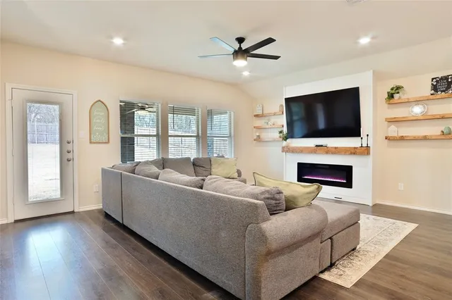 a living room with furniture flat screen tv and a fireplace
