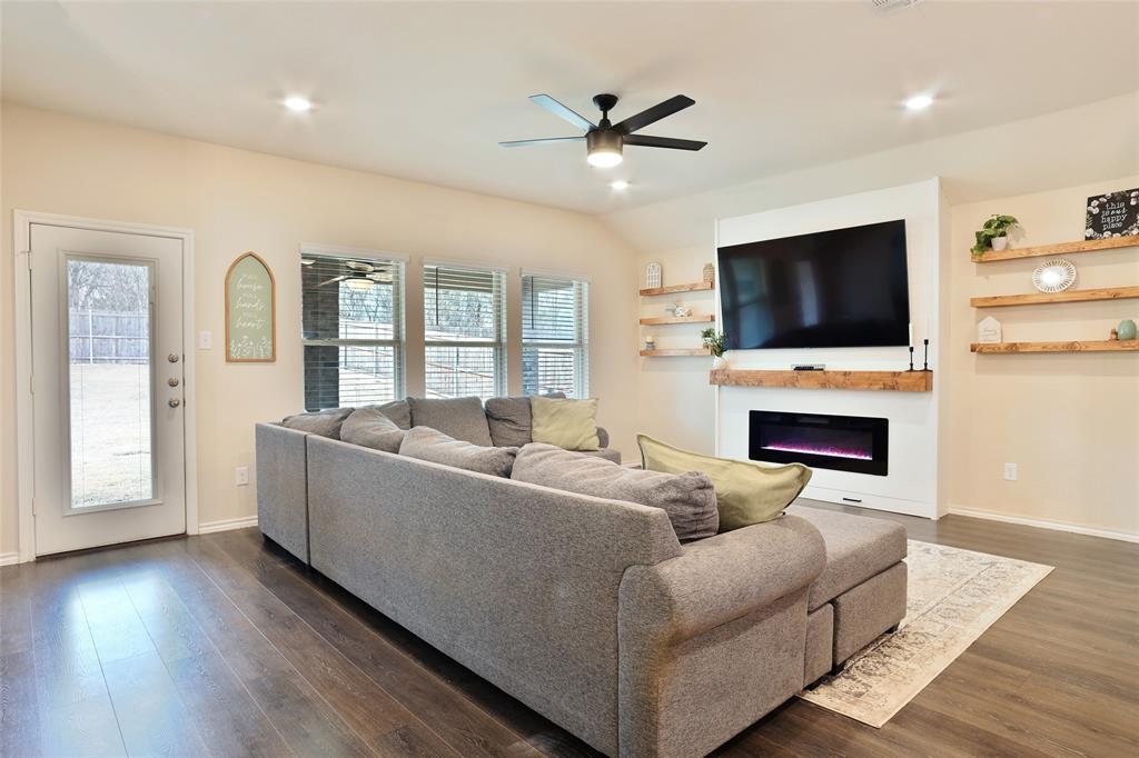 2213 Rosemary Way Anna, TX 75409 - Photo 13 of 27 a living room with furniture a fireplace and a flat screen tv