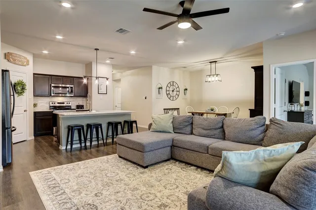 a spacious bedroom with a bed a couch and a potted plant