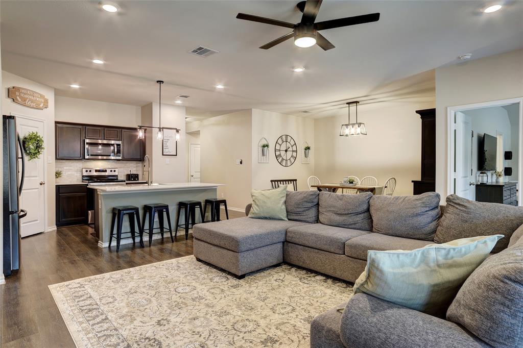 2213 Rosemary Way Anna, TX 75409 - Photo 16 of 27 a living room with furniture kitchen view and a wooden floor