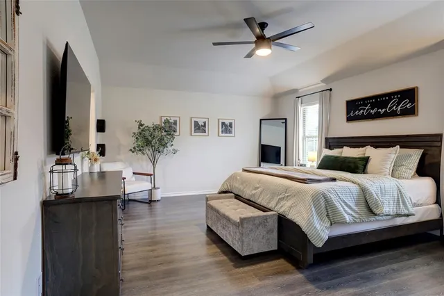 a bedroom with a large bed and a chandelier