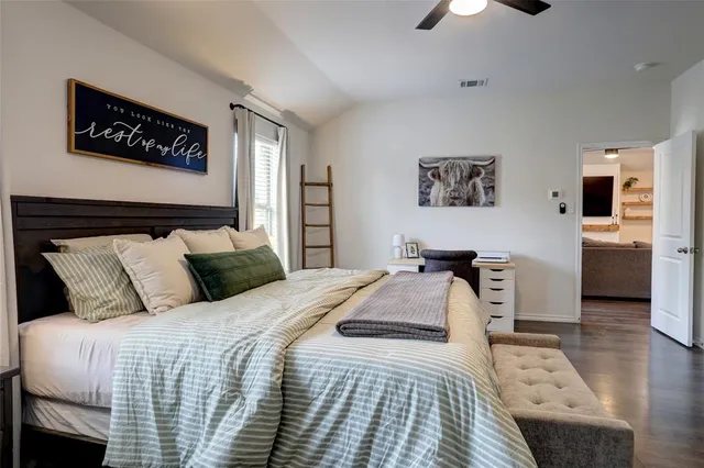 a en suite bathroom with a granite countertop double vanity and a mirror