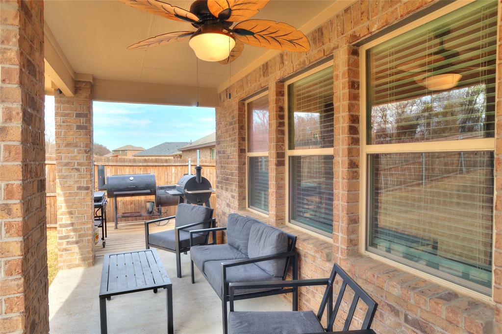 2213 Rosemary Way Anna, TX 75409 - Photo 22 of 27 a dining room with furniture large windows and wooden floor