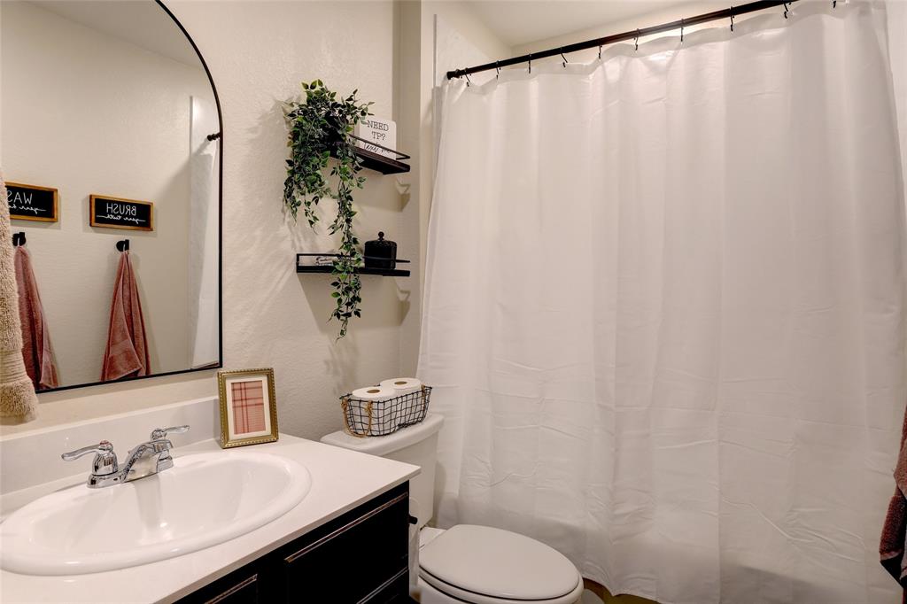 2213 Rosemary Way Anna, TX 75409 - Photo 6 of 27 a bathroom with a sink vanity mirror and toilet