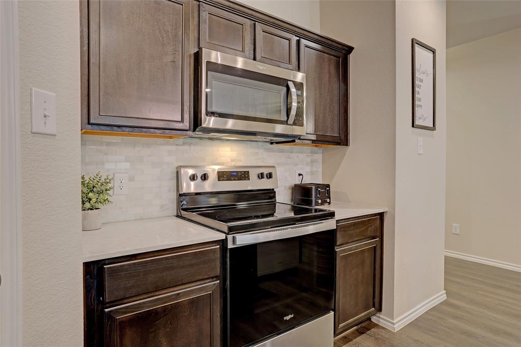 2213 Rosemary Way Anna, TX 75409 - Photo 10 of 27 a kitchen with stainless steel appliances a stove a microwave and sink