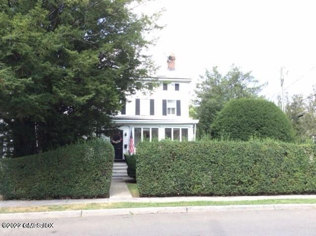 83 William Street, Unit 1 Greenwich, CT 06830 - Photo 2 of 10 a view of a house with a yard and plants
