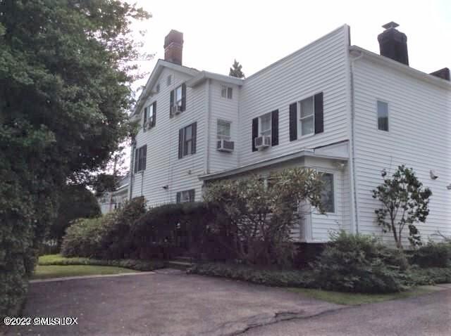 83 William Street, Unit 1 Greenwich, CT 06830 - Photo 3 of 10 a front view of a house with a yard