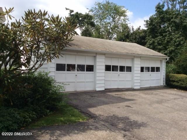 83 William Street, Unit 1 Greenwich, CT 06830 - Photo 4 of 10 a white house that has a tree in front of it