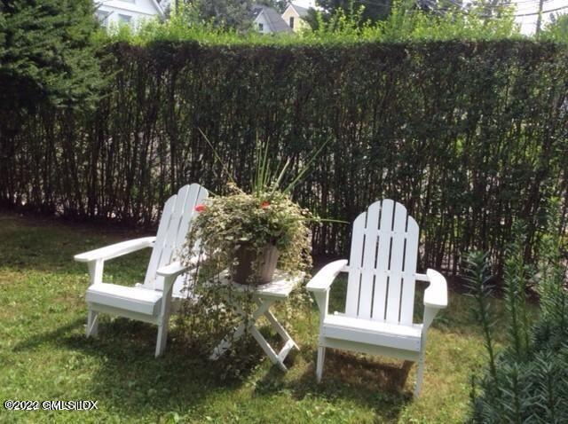 83 William Street, Unit 1 Greenwich, CT 06830 - Photo 5 of 10 a view of a chair and table in the backyard