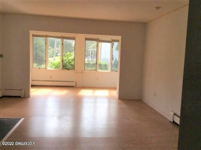 83 William Street, Unit 1 Greenwich, CT 06830 - Photo 6 of 10 a view of empty room with wooden floor and fan