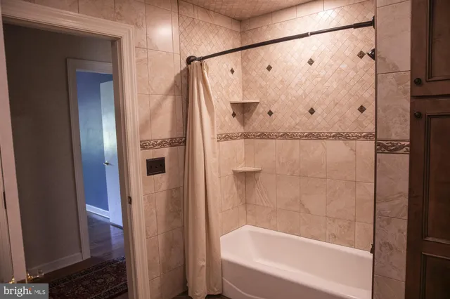 a bathroom with a sink a mirror and a shower