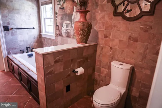 a view of a livingroom with wooden floor and a fireplace