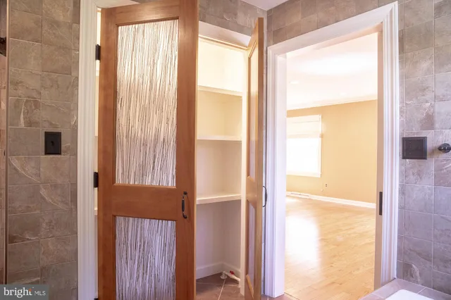 a kitchen with a stove a sink dishwasher and a refrigerator with wooden floor
