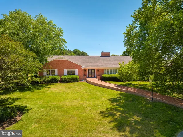 an aerial view of residential house with outdoor space and swimming pool