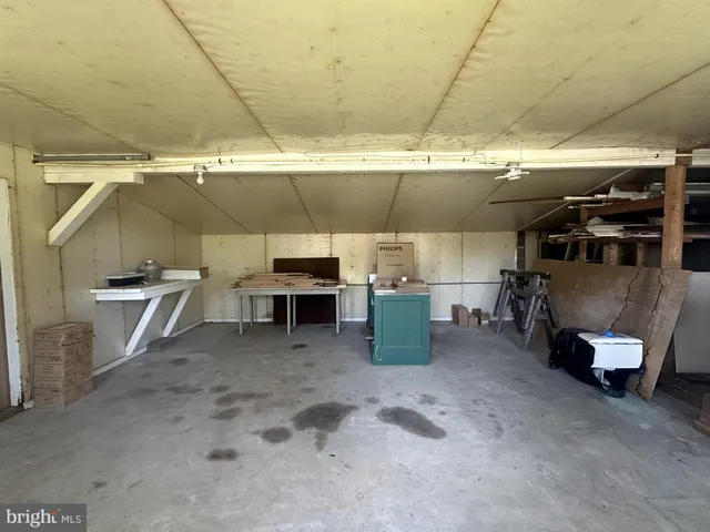 a view of hallway with stairs and wooden floor
