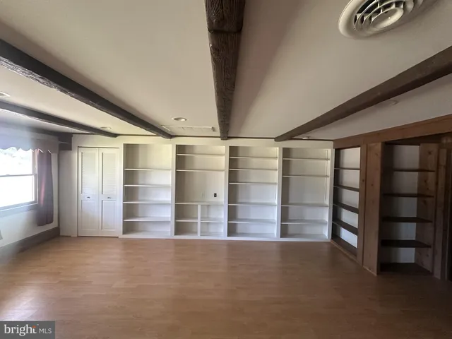 an empty room with a empty space and windows