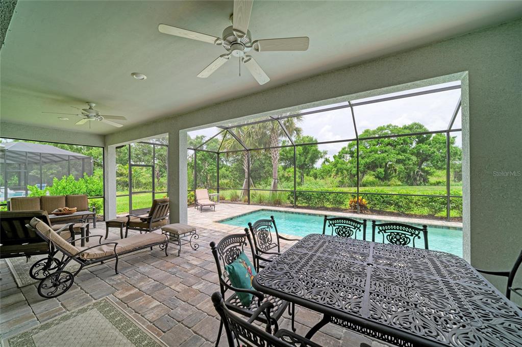 16341 Hidden Oak Loop Lakewood Ranch, FL 34211 - Photo 57 of 76 a view of a dining room with furniture window and outside view