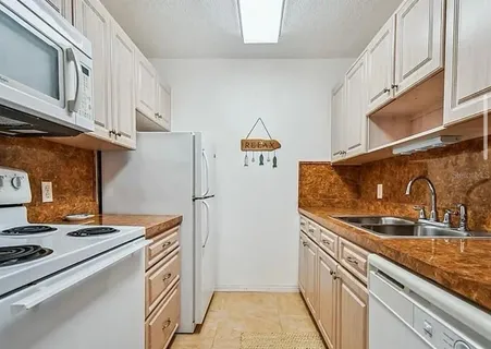 a kitchen with stainless steel appliances granite countertop a sink and a stove