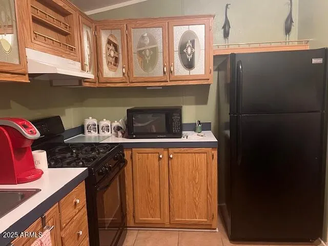 a kitchen with stainless steel appliances granite countertop a refrigerator and a stove