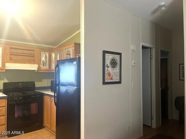 a kitchen with a refrigerator and a stove top oven