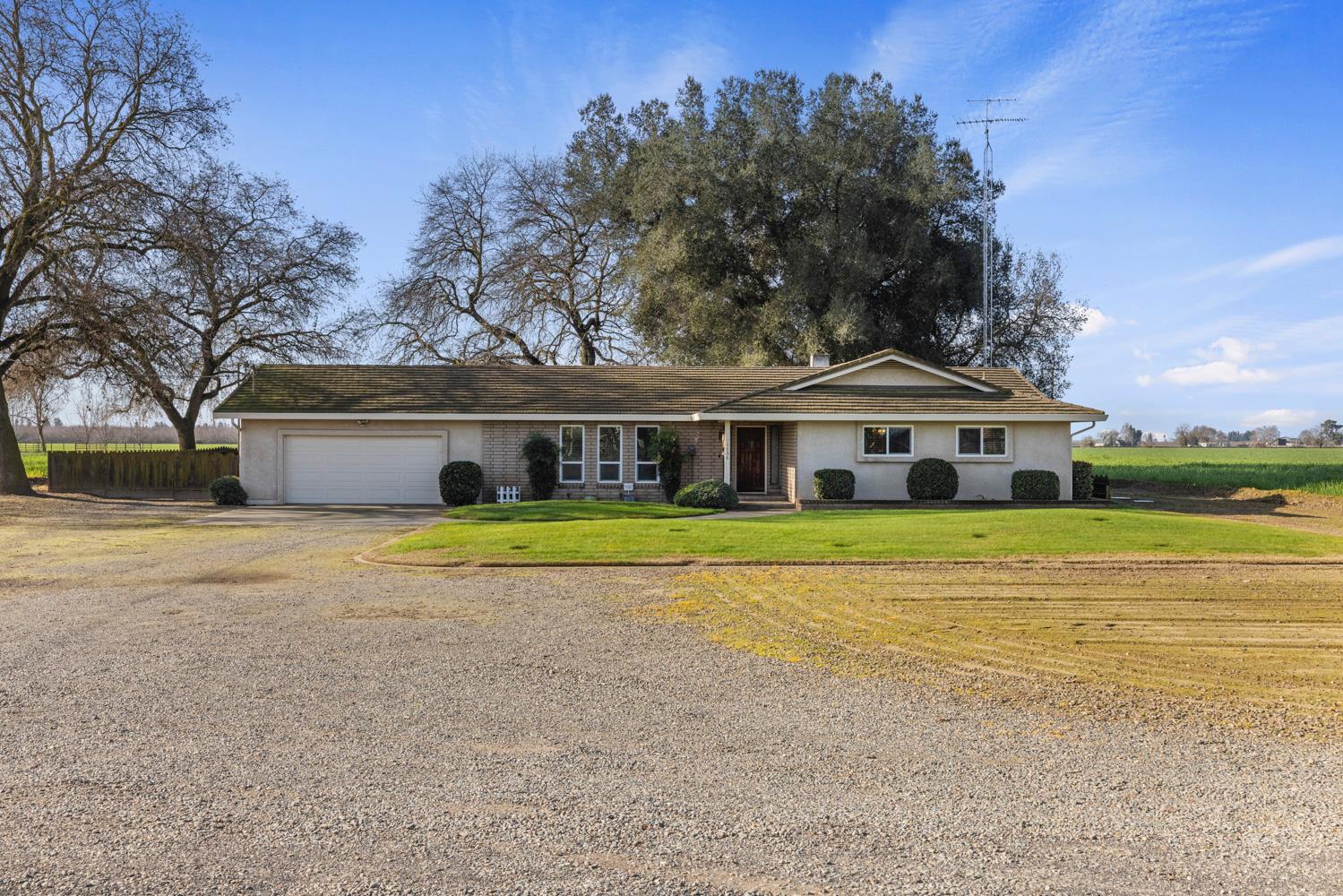 24836 Arthur Road Escalon, CA 95320 - Photo 1 of 47 a view of a white house with a large pool and a big yard