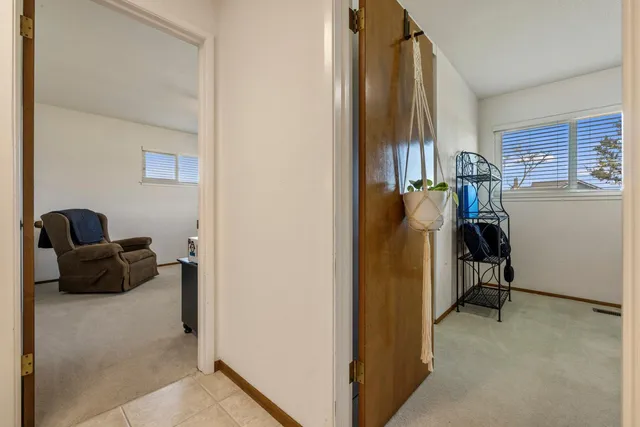 a view of hallway with livingroom and a window
