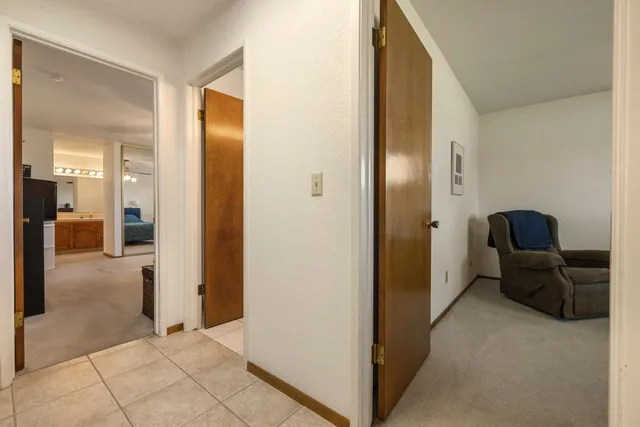 a view of a living room with furniture and a view of kitchen