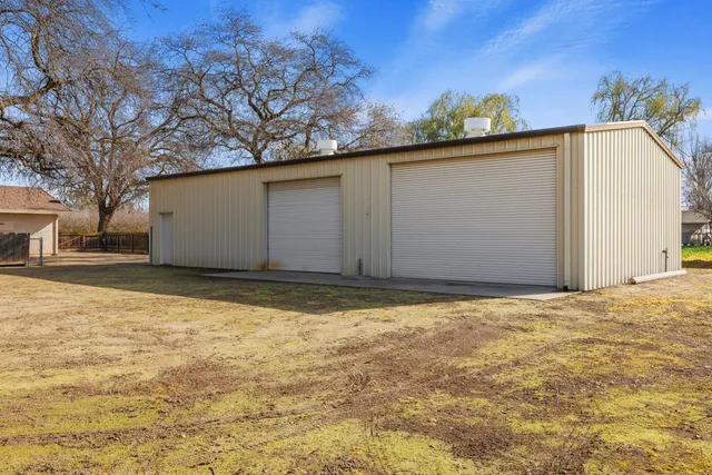a view of a yard with a house in the background