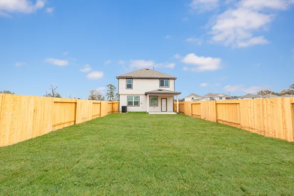 a view of a house with a yard and a garden