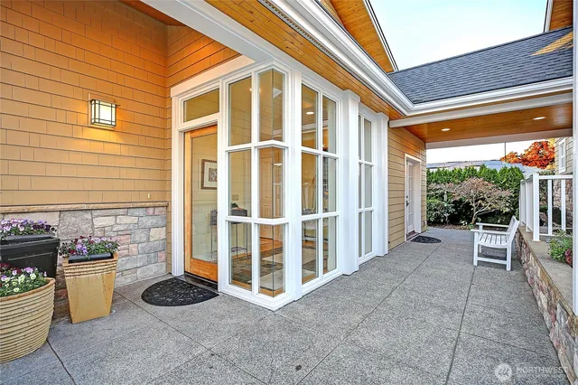 a view of a living room with wooden floor and windows